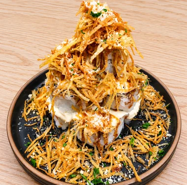 Rocky Mountain Roll piled high with crispy shredded potato and cream cheese sauce